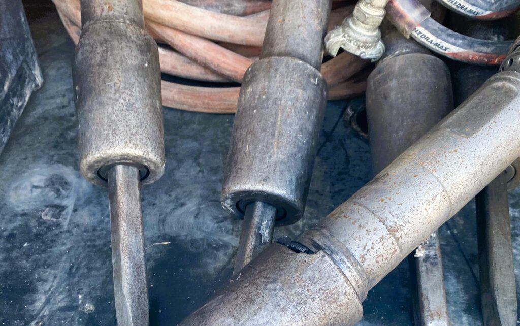 pneumatic tools and hoses in a pile