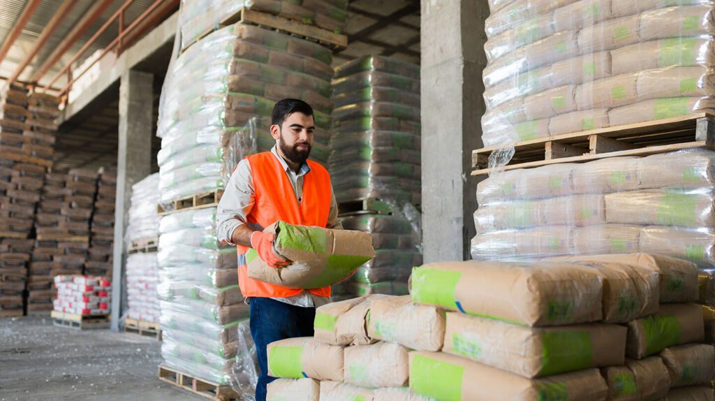 Man stacking bags of dry cement