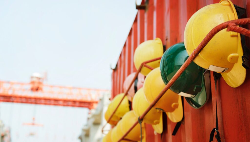 Hard hats on rebar shelf on an industrial job site