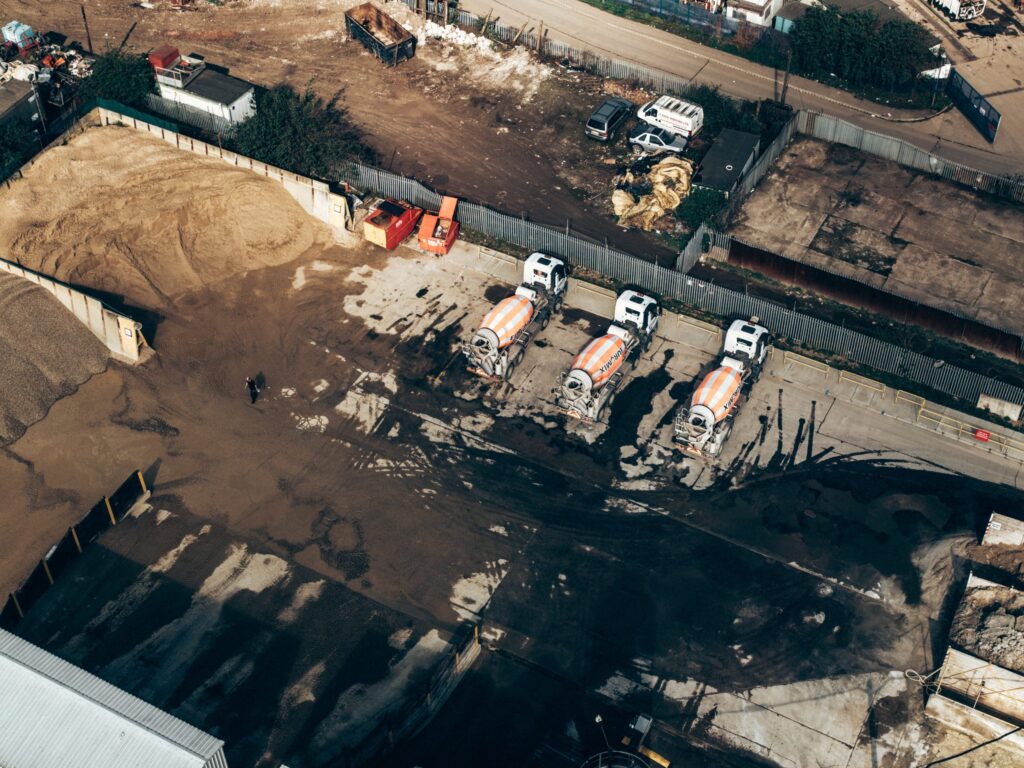 Overhead view of ready mix concrete trucks on industrial site
