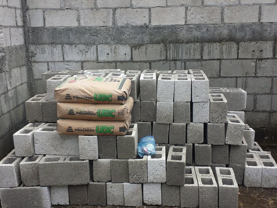 Concrete blocks and bagged cement piled on a job site