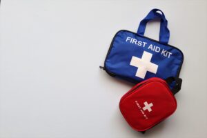 red and blue first aid kits against white background