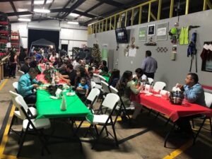 Families eating at red and green tables inside General Chipping's home office