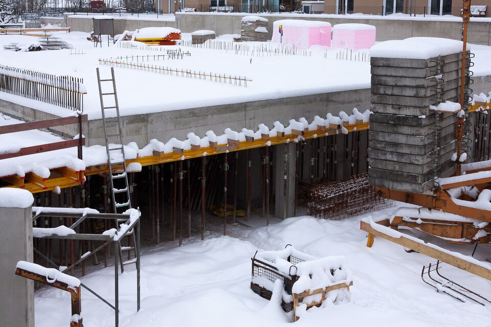 Concrete construction site covered in snow and ice