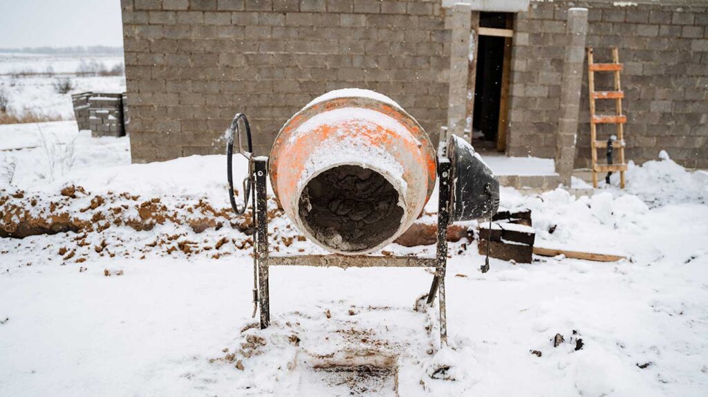Mini concrete mixer on snowy job site