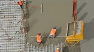 Crew pouring central mixed concrete on a job site