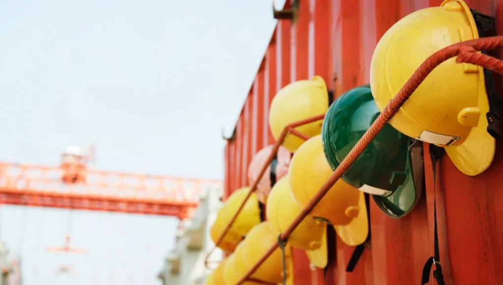 Hard hats on rebar shelf on an industrial job site